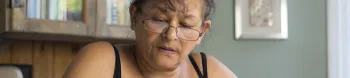 Woman looking down at her tablet